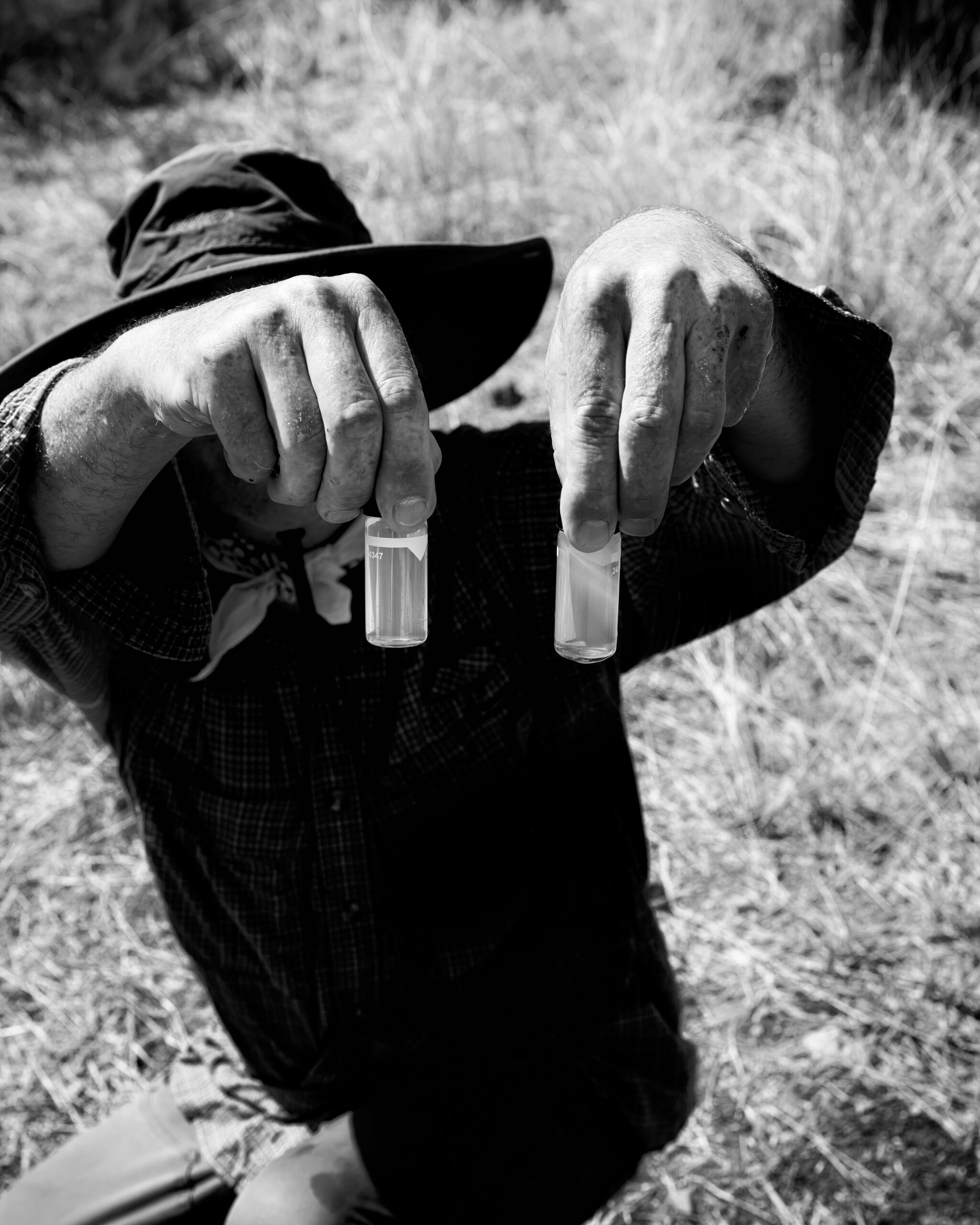 Chris Gardner tests the water at the well of Susan Wethington, which has become contaminated. She believes the contamination is a result of new activity upstream from her home at South32’s Hermosa mine project, a new manganese and zinc mine in southern Arizona.