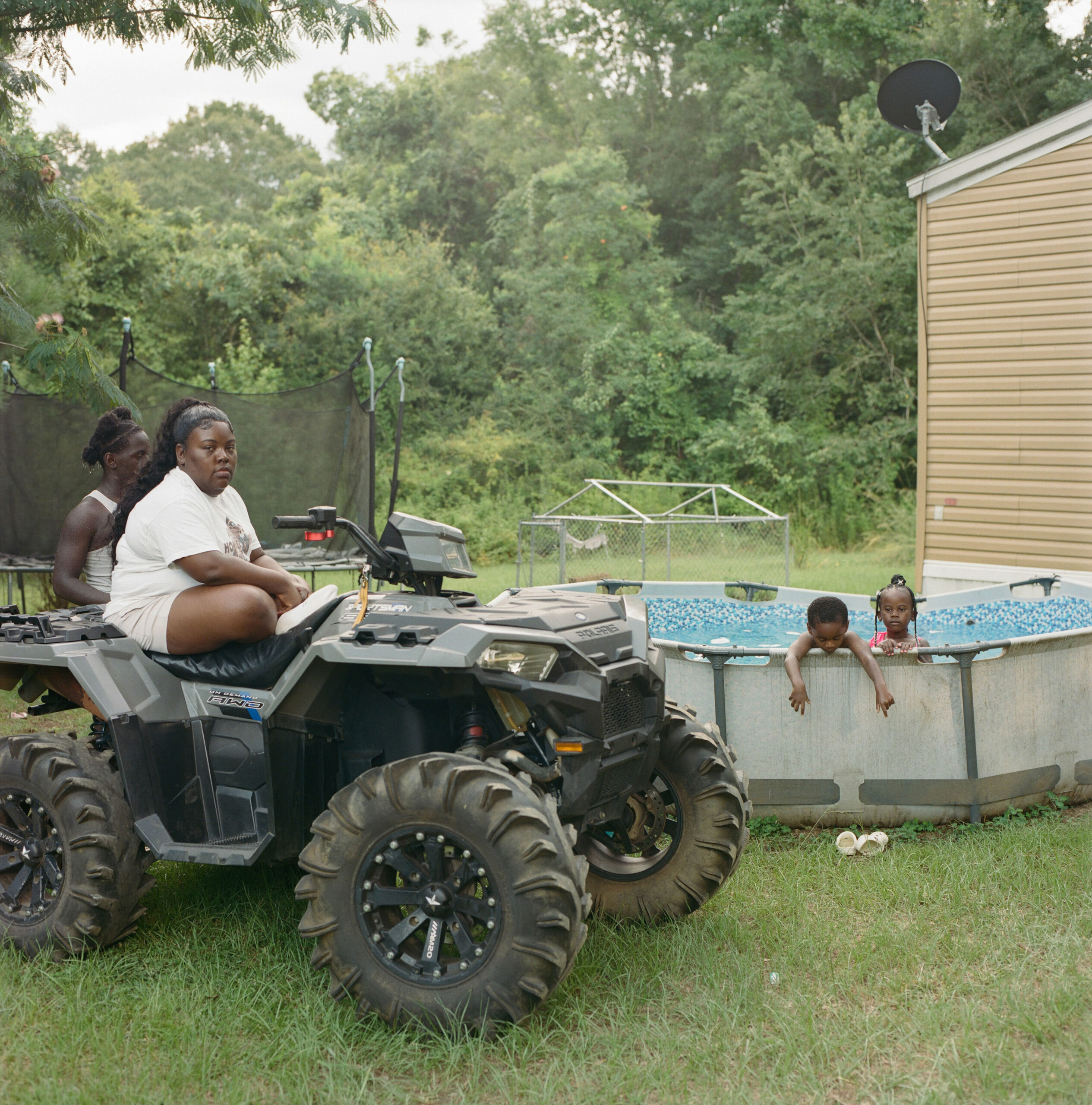 Angel Walker, 37, a Gloster resident, watches her children play in the pool.