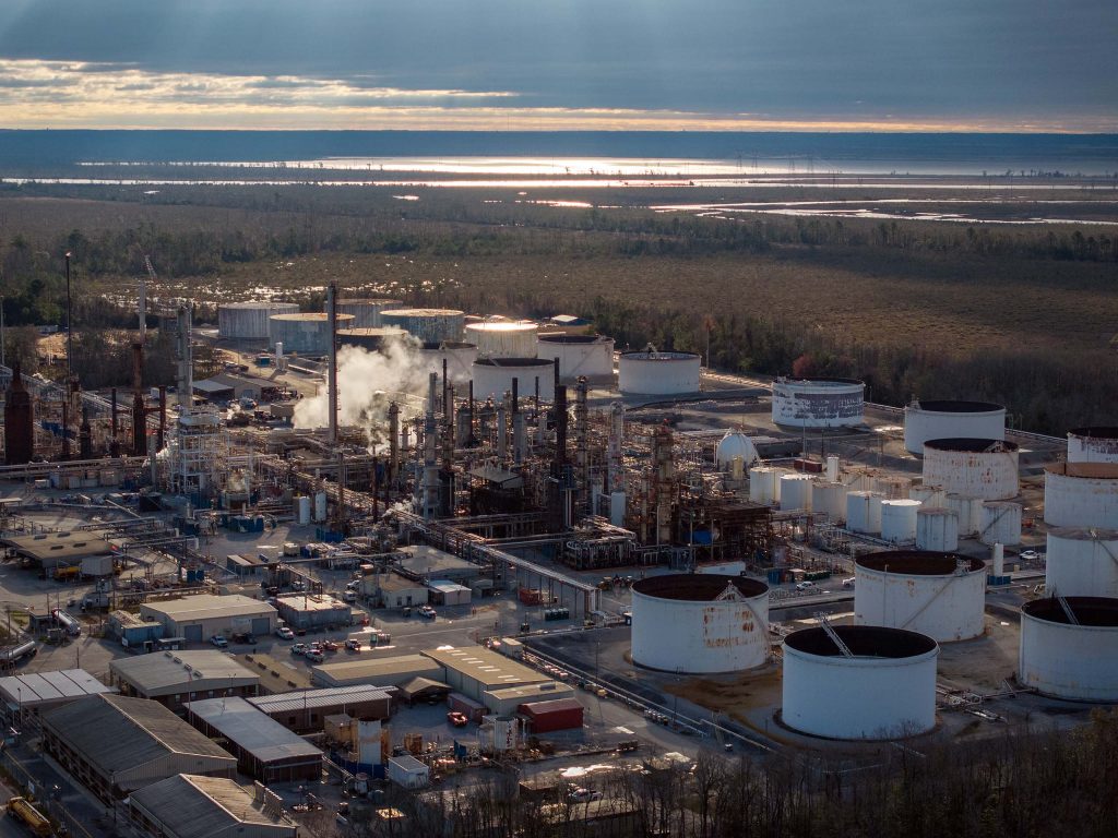 A refinery active near marshland.