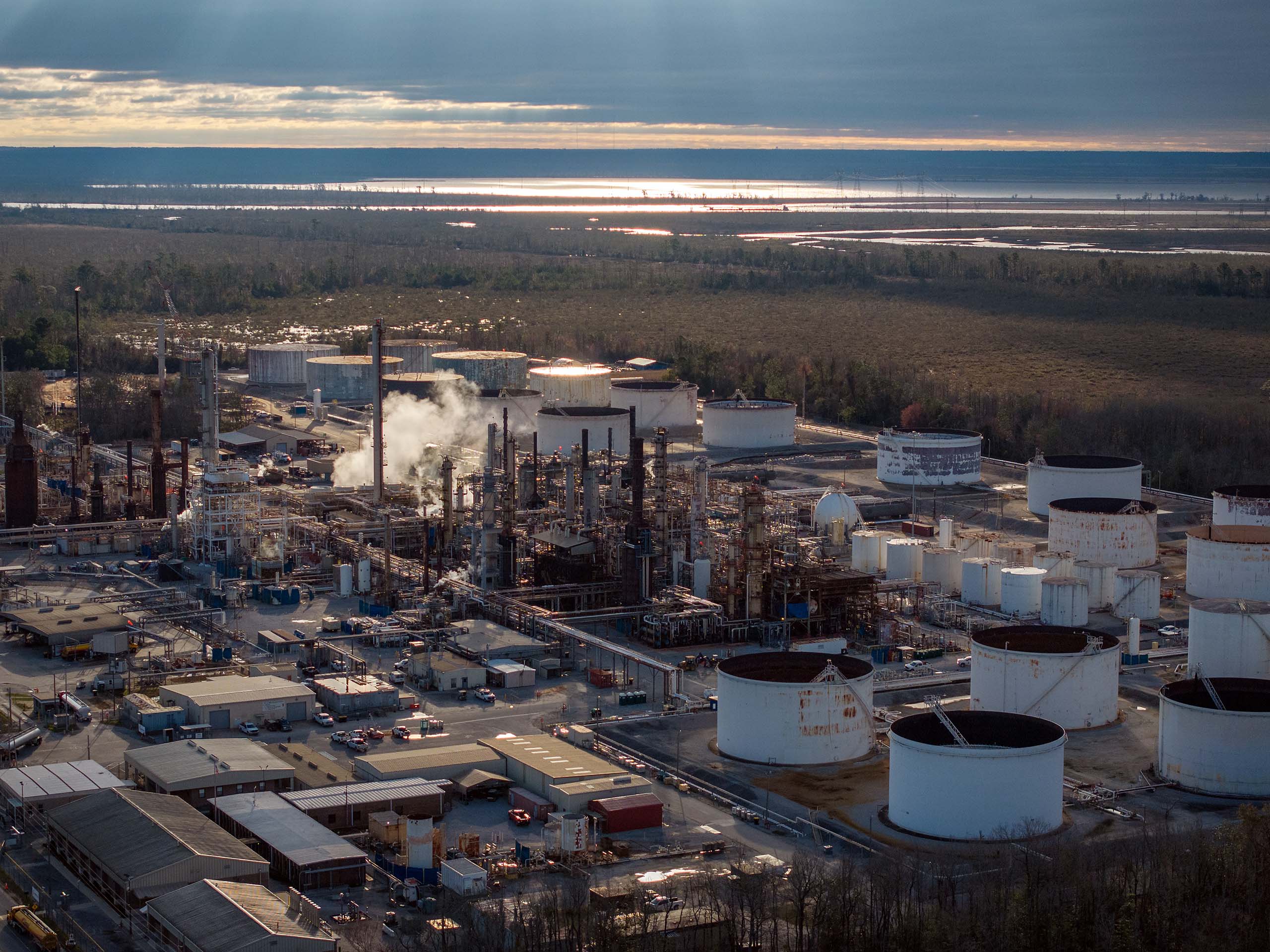 A refinery active near marshland.