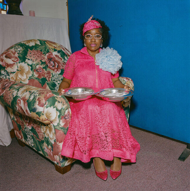 Lavone Morris, 55, a health care worker and church evangelist, holding the silver plates for donations.